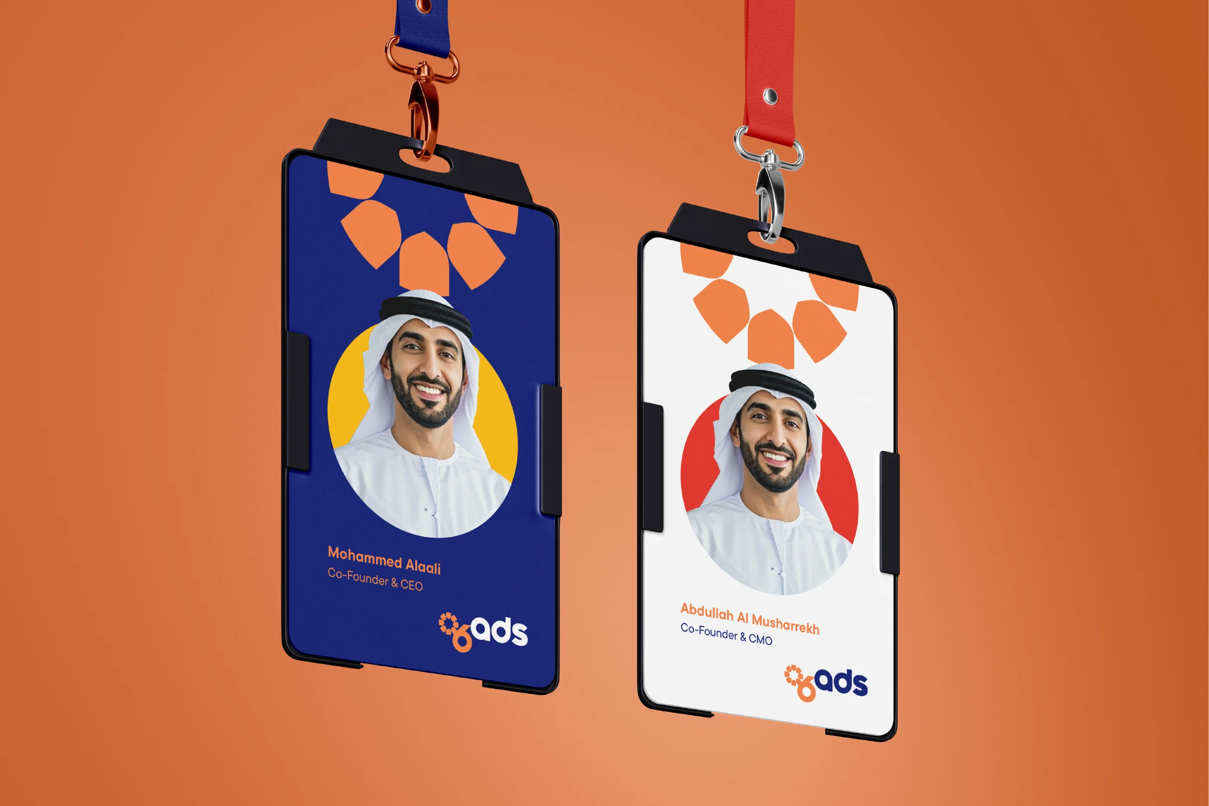 Two ID cards on lanyards against orange, one navy and one white, each with a portrait in a coloured circle, a name and the logo.
