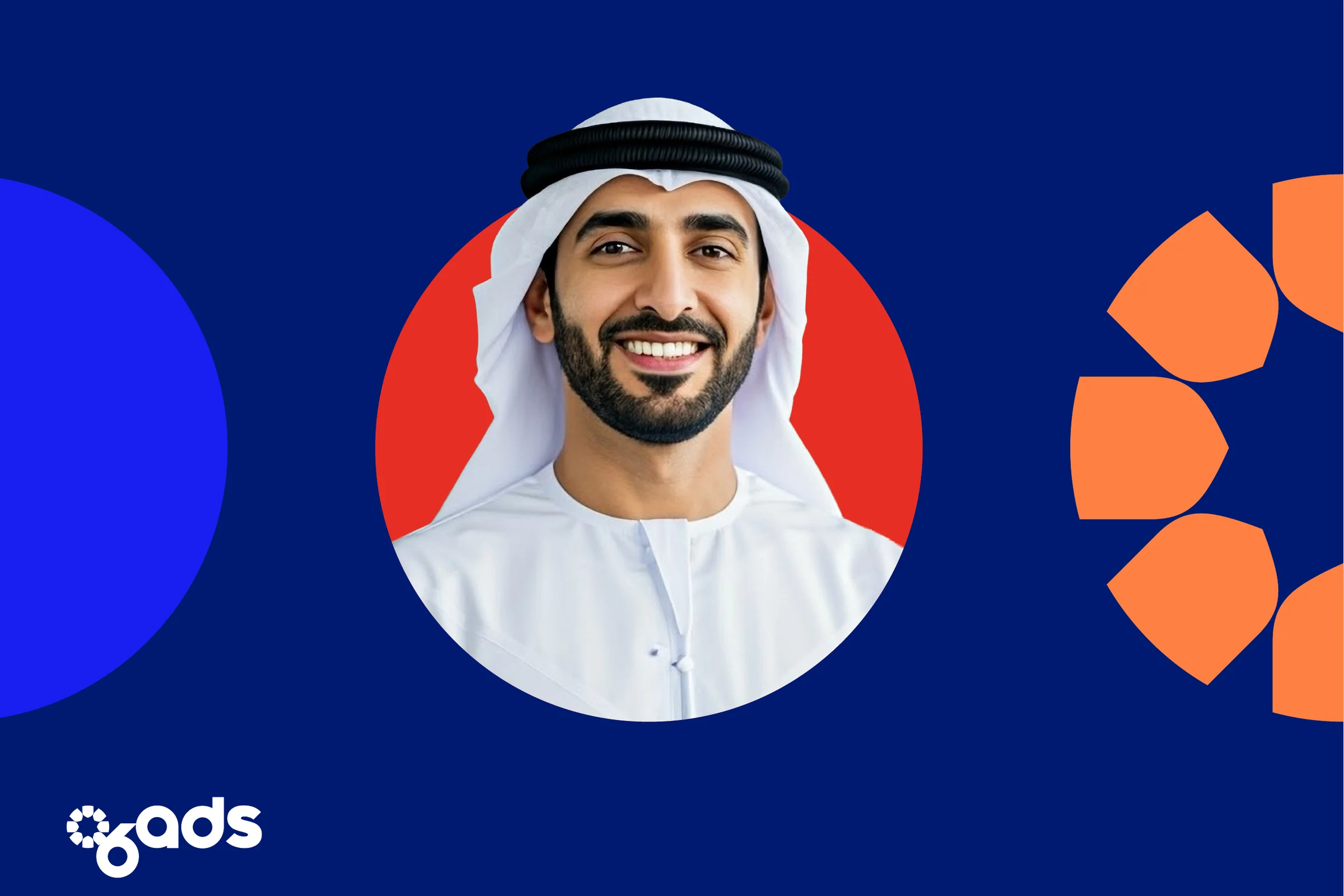 A smiling man in a white ghutra inside a red circle on navy, between a blue half-circle and orange petals, with the logo at the lower left.