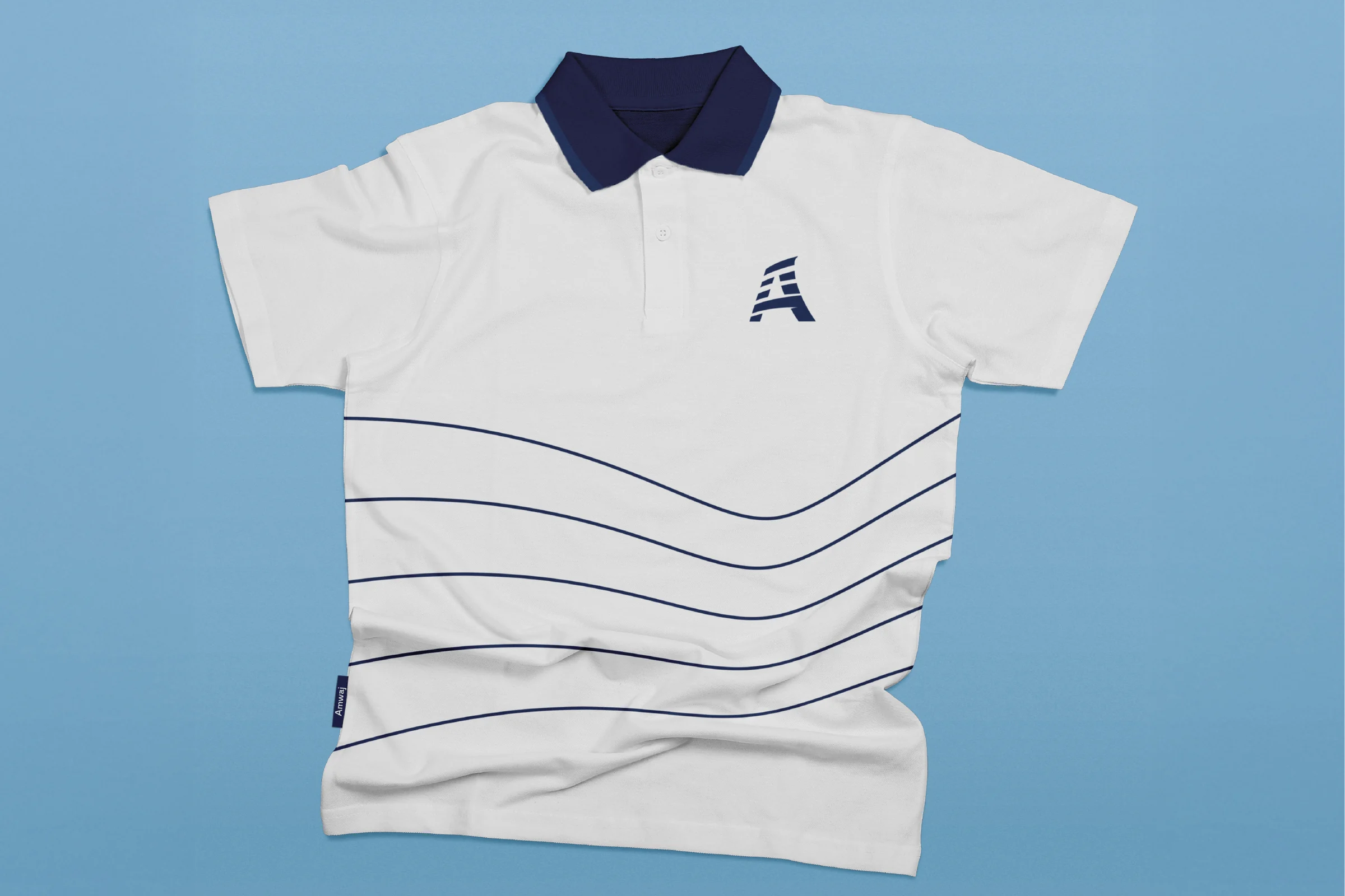 A white polo shirt with a navy collar, the navy emblem on the chest and five navy wave lines across the front, on light blue.