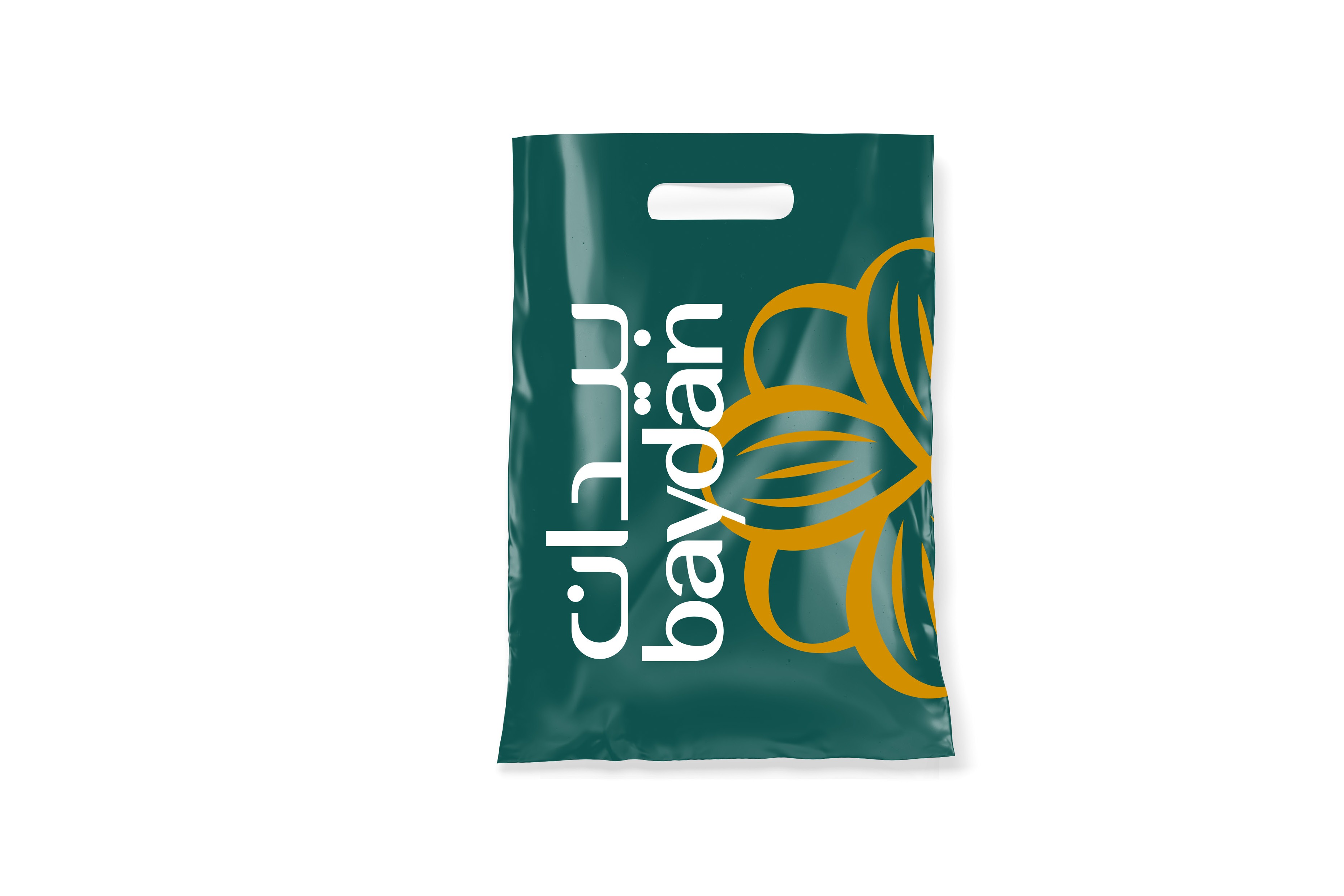 A green plastic carrier bag with the logo set vertically in white and large gold almonds.