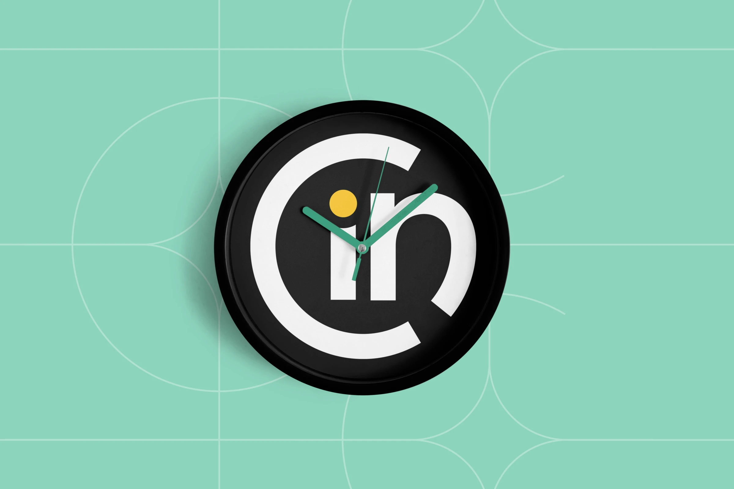 A wall clock with the symbol on its face and green hands, on Ocean green with hairline figures.