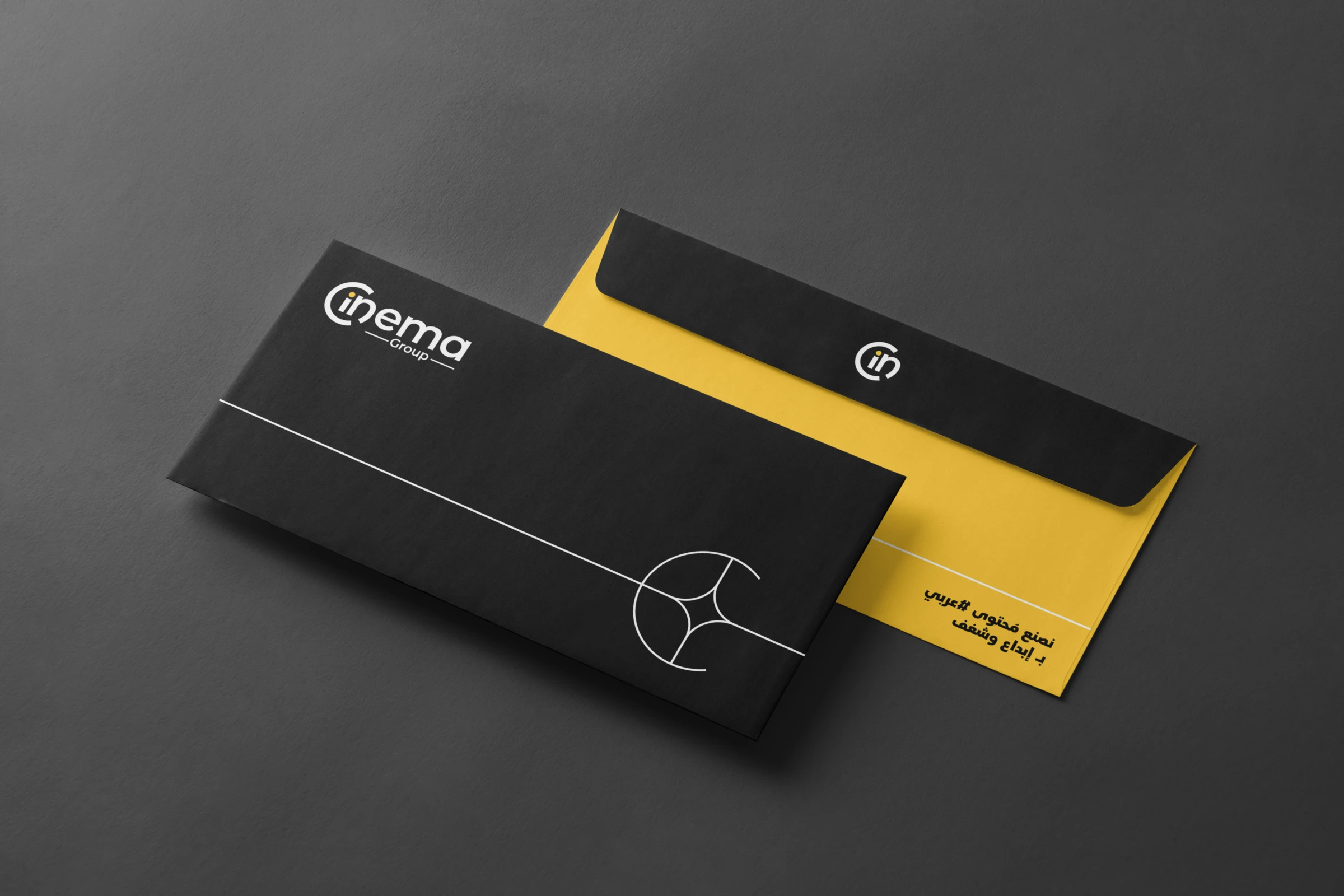 A black envelope with the wordmark and a hairline figure, over a yellow envelope with the symbol.