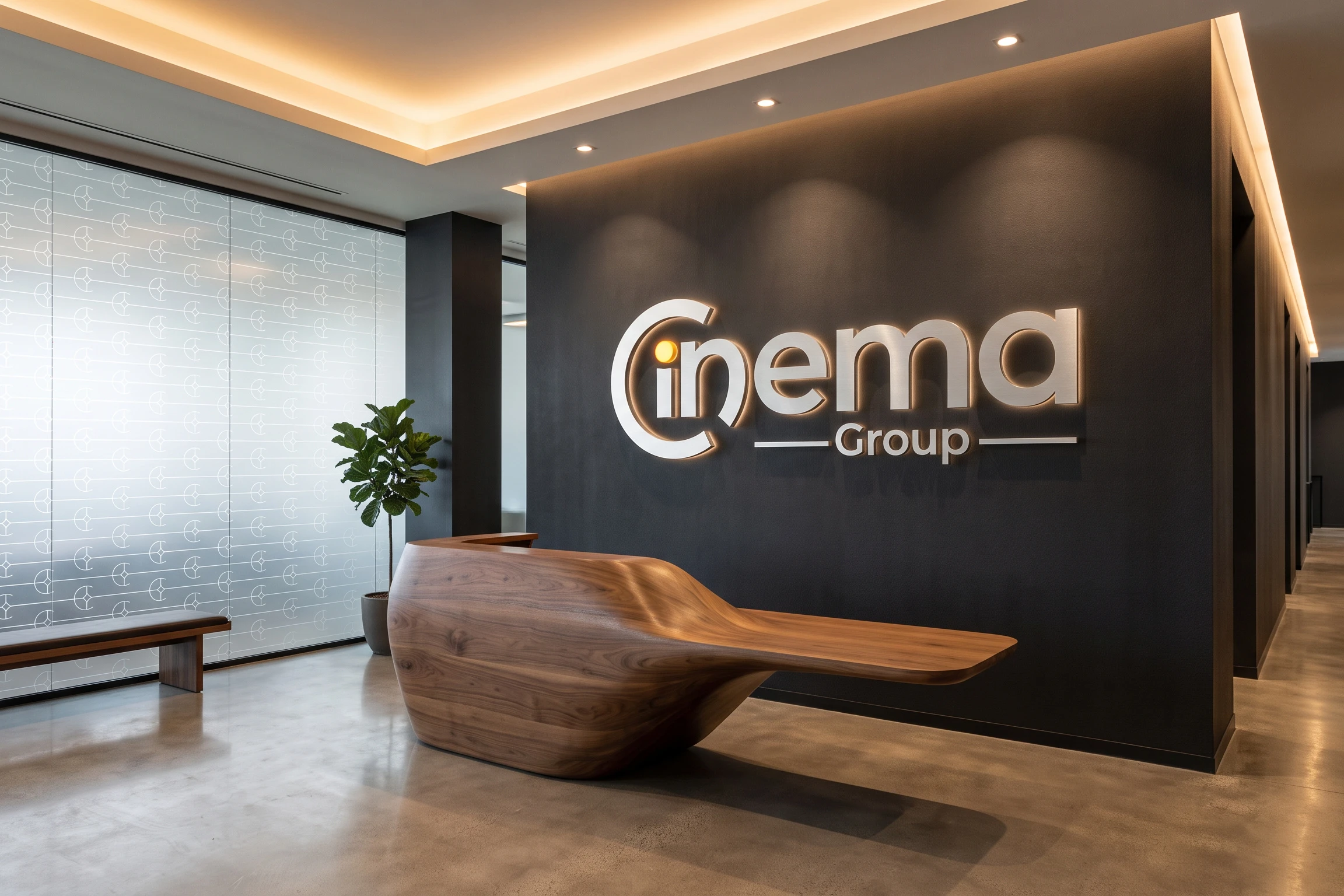 A reception with a sculpted walnut desk before a charcoal wall carrying the logo in lit metal letters, and the pattern frosted on the glass beside it.