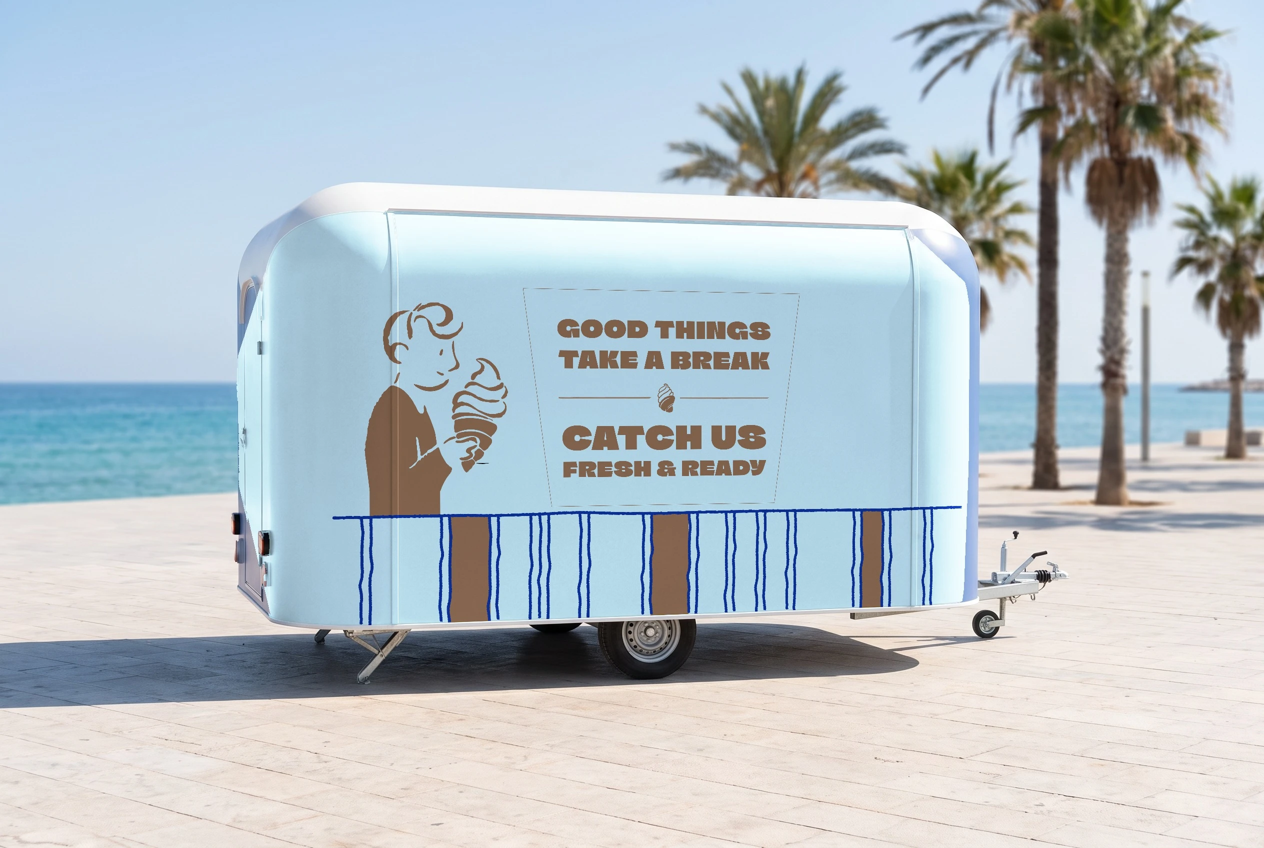 A baby-blue food trailer parked on a seaside promenade with palm trees, its side printed with the boy holding a croissant cone, the slogan GOOD THINGS TAKE A BREAK, CATCH US FRESH & READY, and navy and brown stripes along the bottom.