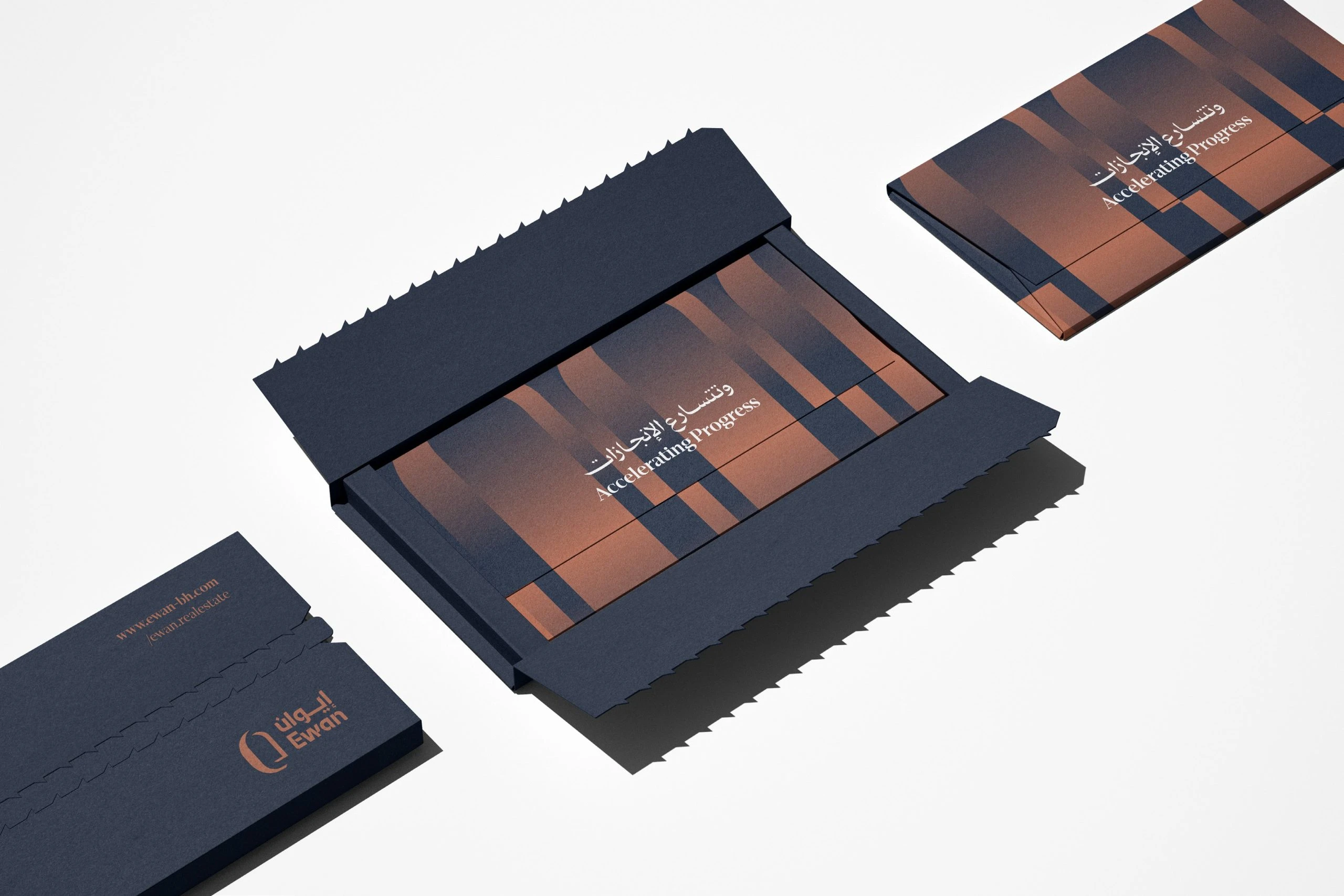 Navy tear-strip envelopes on white: one with the terracotta logo and a web address, one torn open to show cards with navy and terracotta arches and the line Accelerating Progress in English and Arabic.