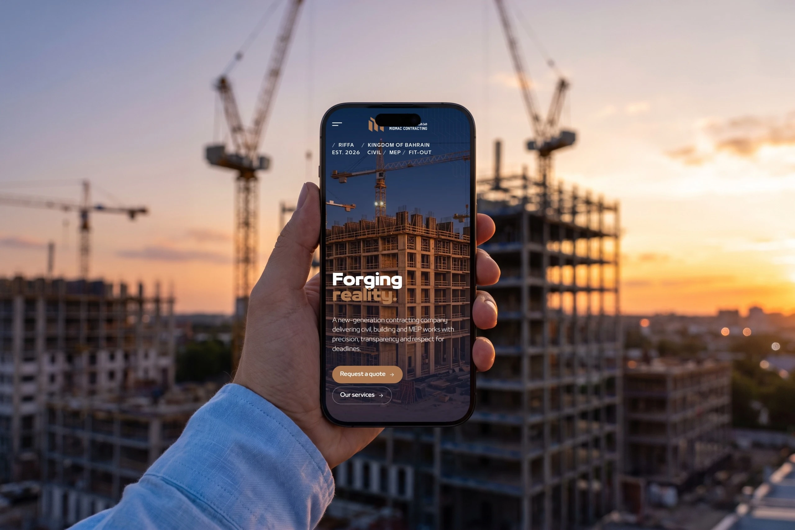 A hand holding an iPhone in front of tower cranes at sunset, showing the home page: Forging reality over a building under construction.