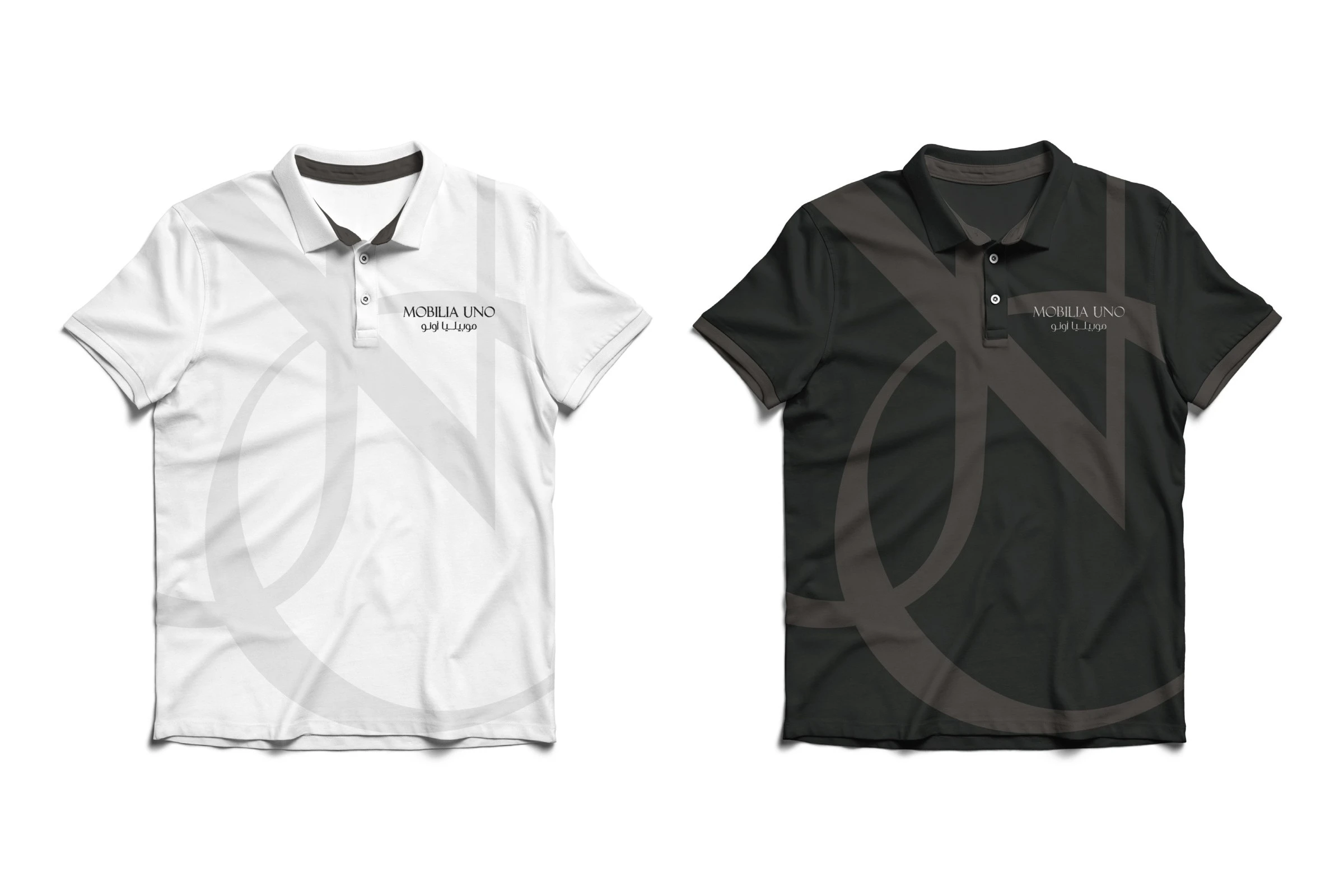A white polo shirt and a black one, each with the logo on the chest and the monogram across the front.