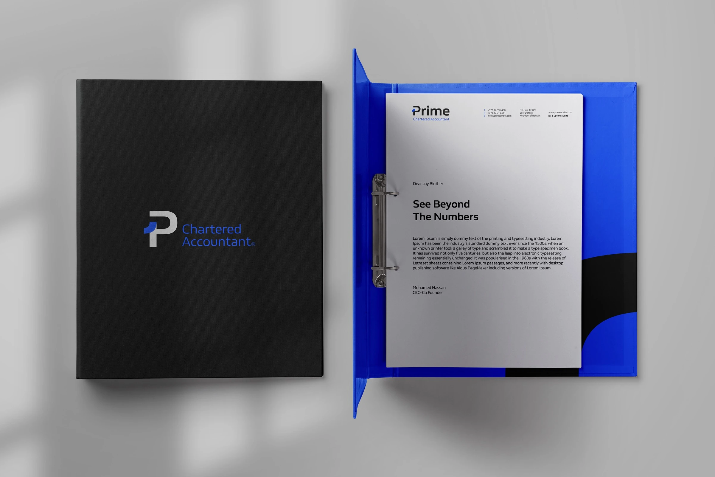 A black folder with the P mark beside an open blue ring binder holding a Prime letterhead.