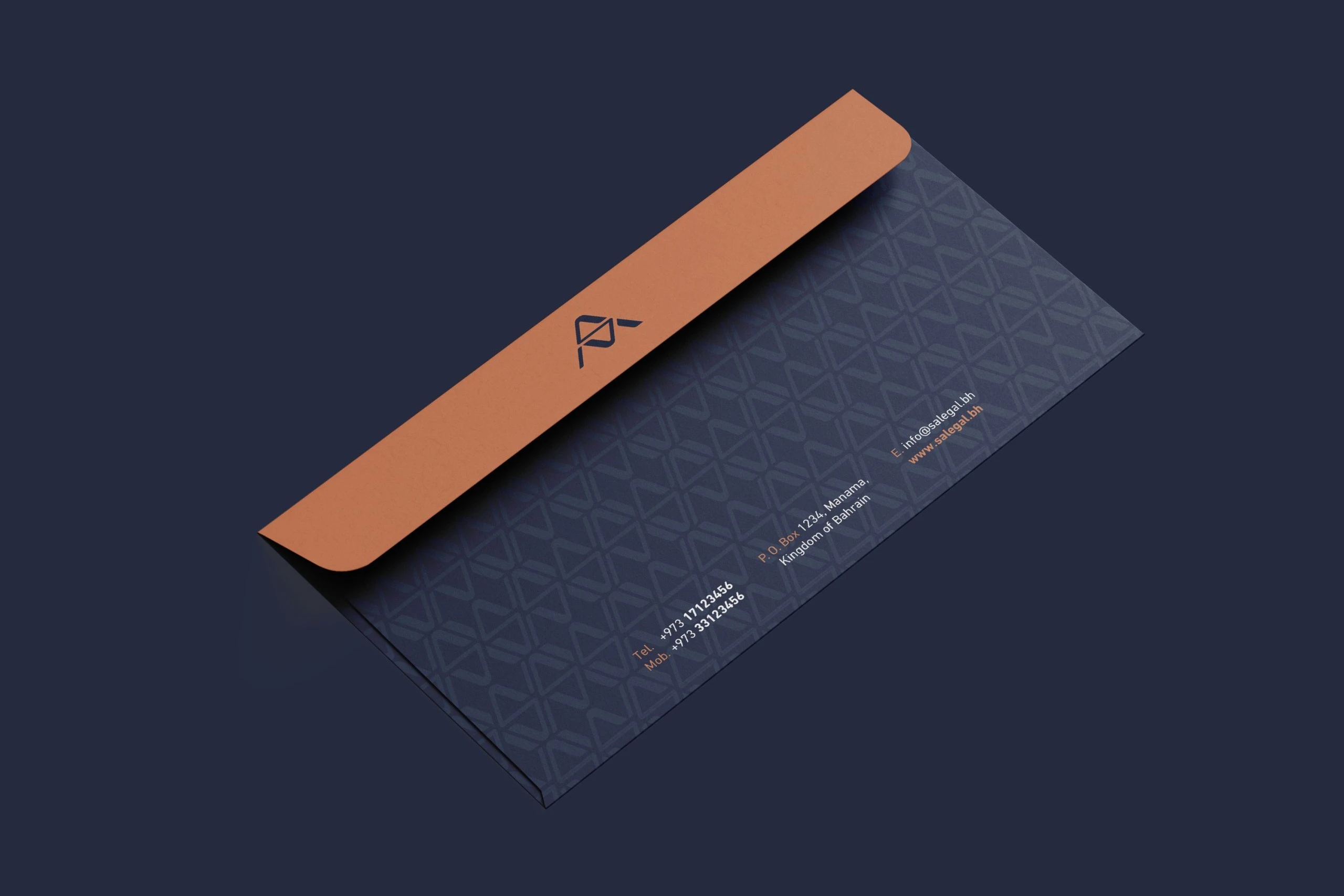 A navy envelope with a copper flap carrying the monogram, its face printed with the pattern in a darker navy.