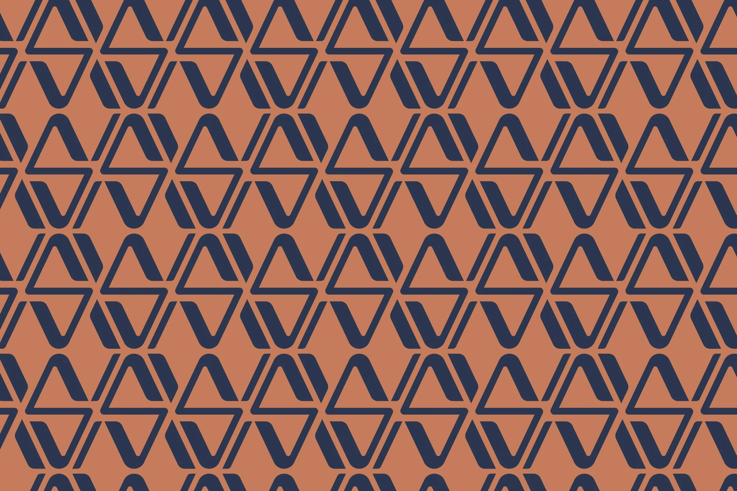 The pattern: rows of the monogram’s angled strokes in navy on copper, interlocking into triangles.
