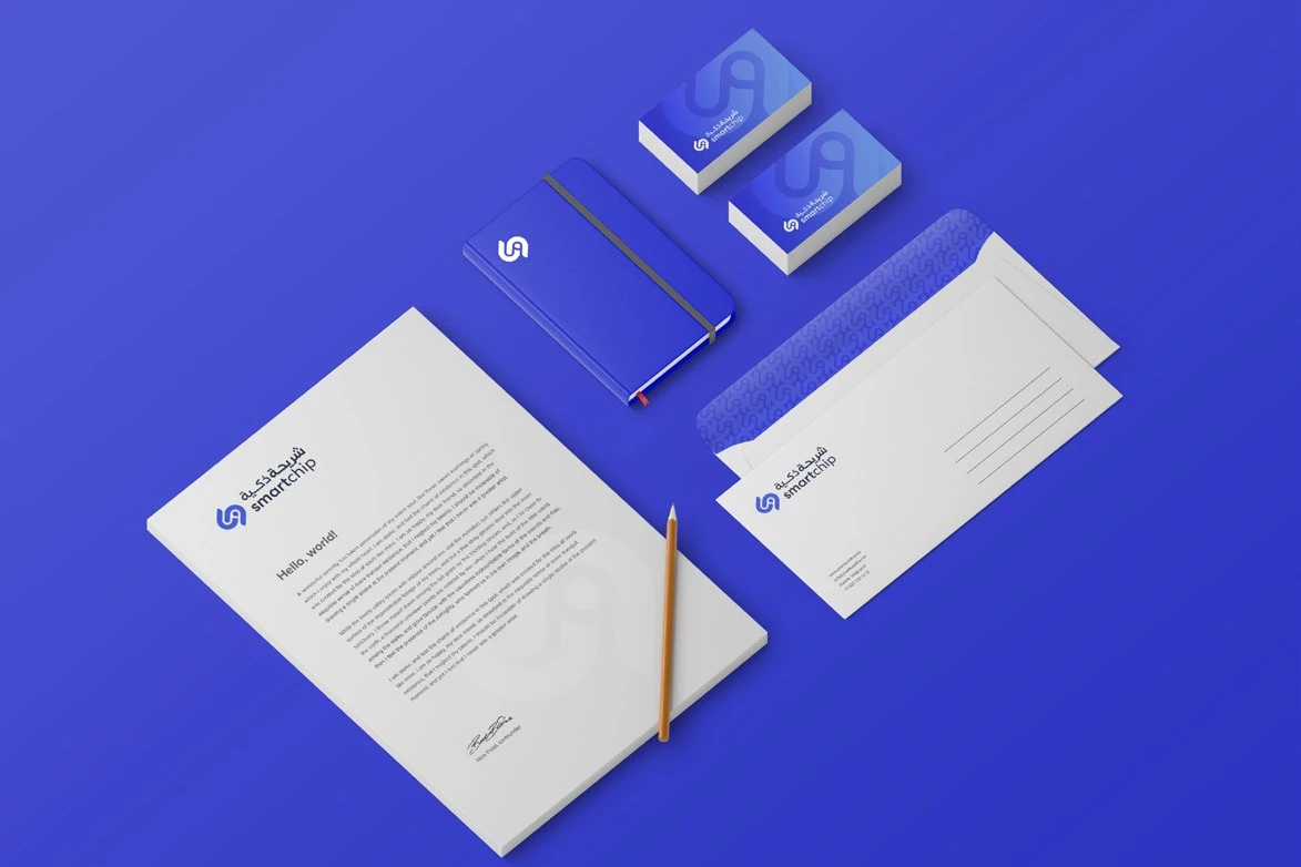 Stationery on blue: letterhead, envelope, business cards and a notebook with the Smart Chip logo.