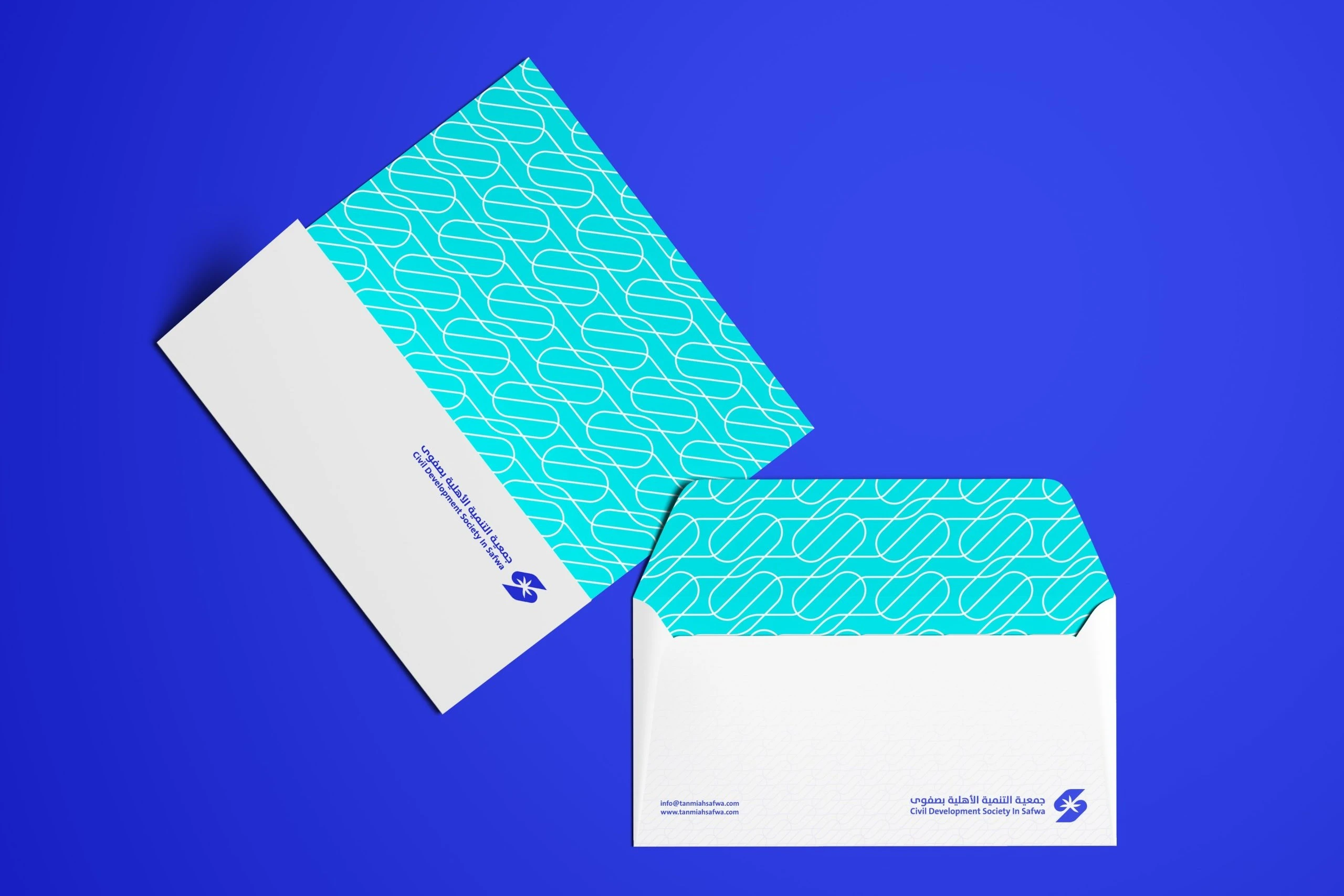 Two white envelopes on royal blue, one open to show a turquoise lining printed with the curve pattern, both with the logo.