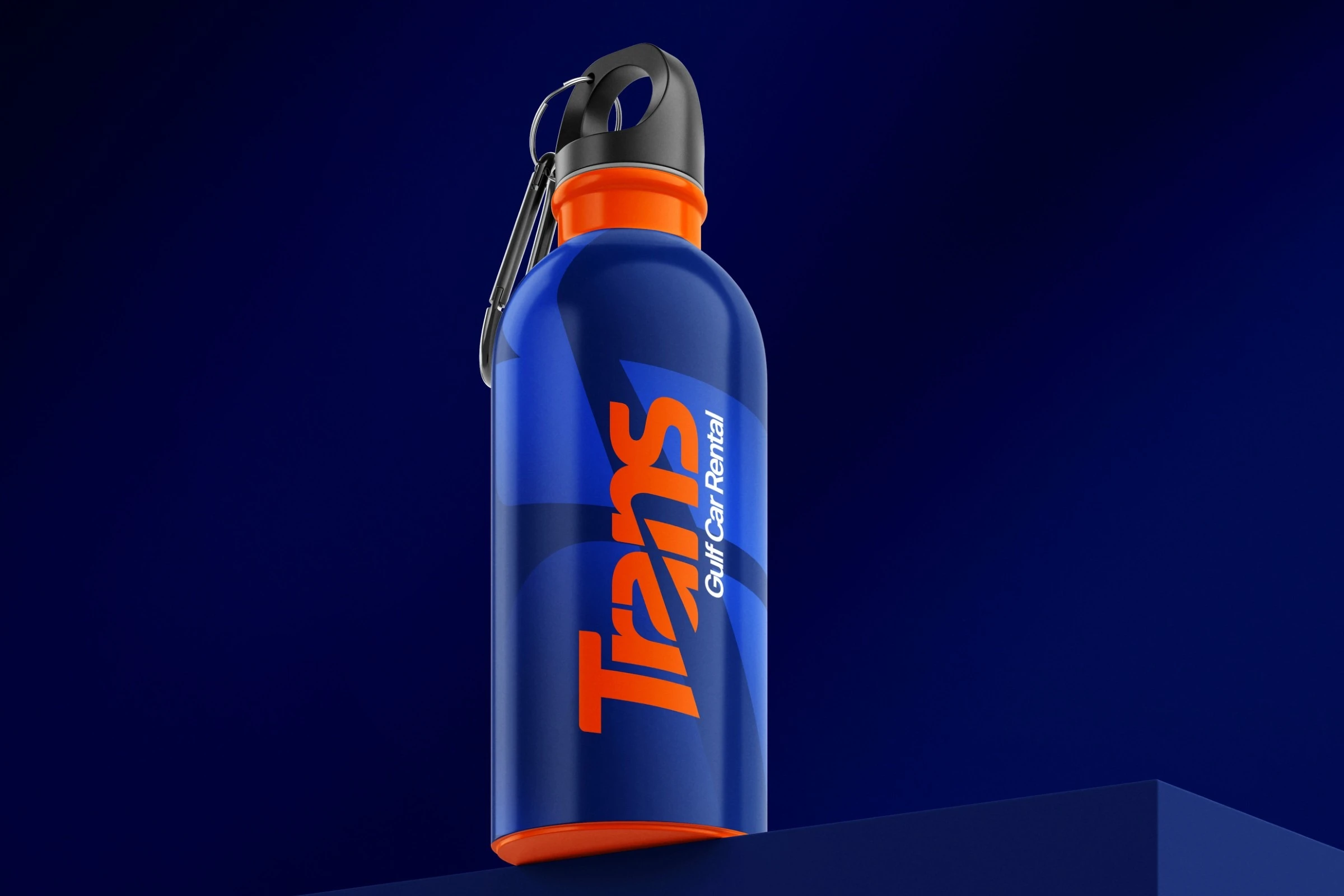 A blue metal water bottle with an orange neck and base and a carabiner cap, the Trans logotype running up its side, on a navy plinth.