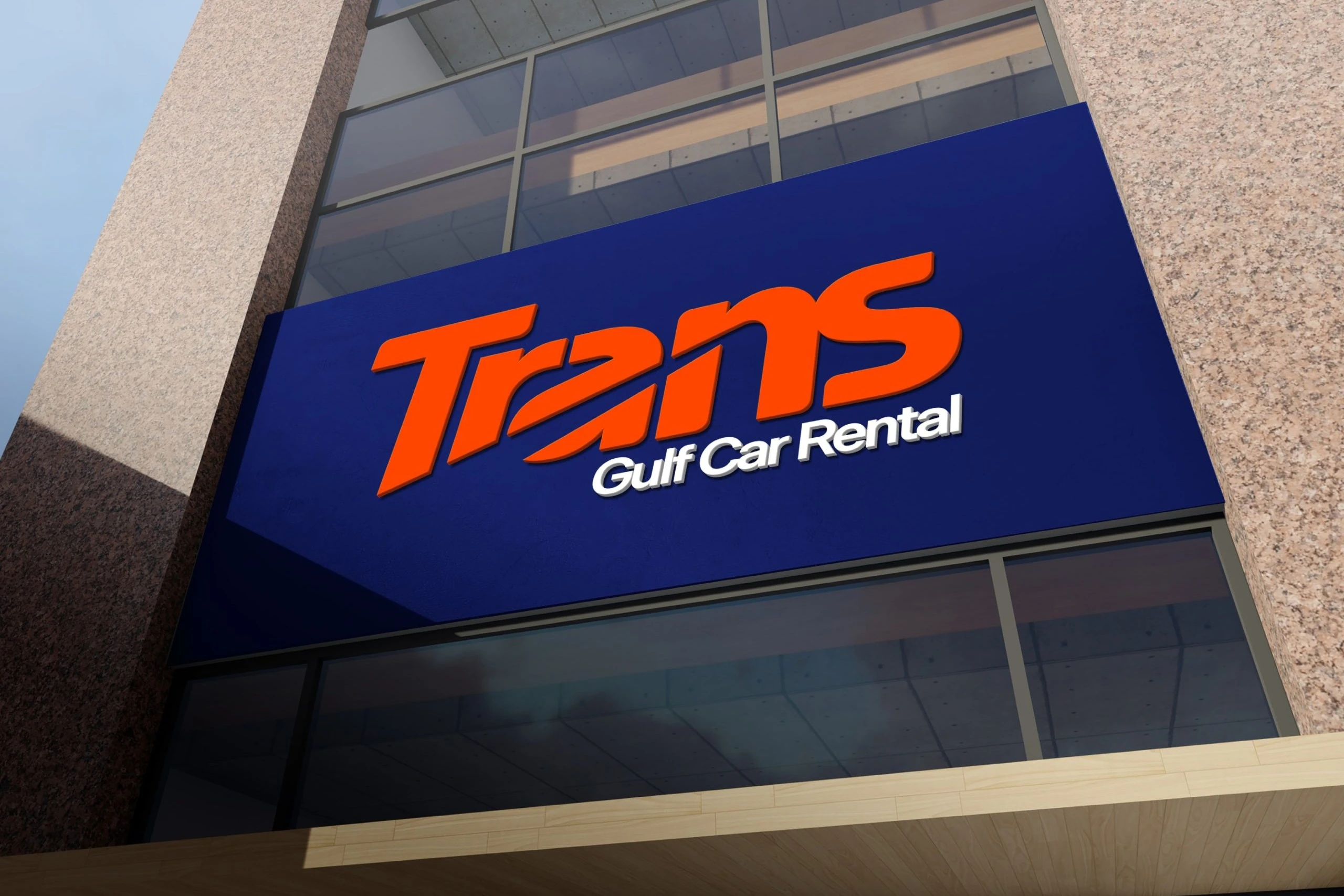 A navy sign across a stone and glass building front, with the Trans logotype in raised orange letters and Gulf Car Rental in white.