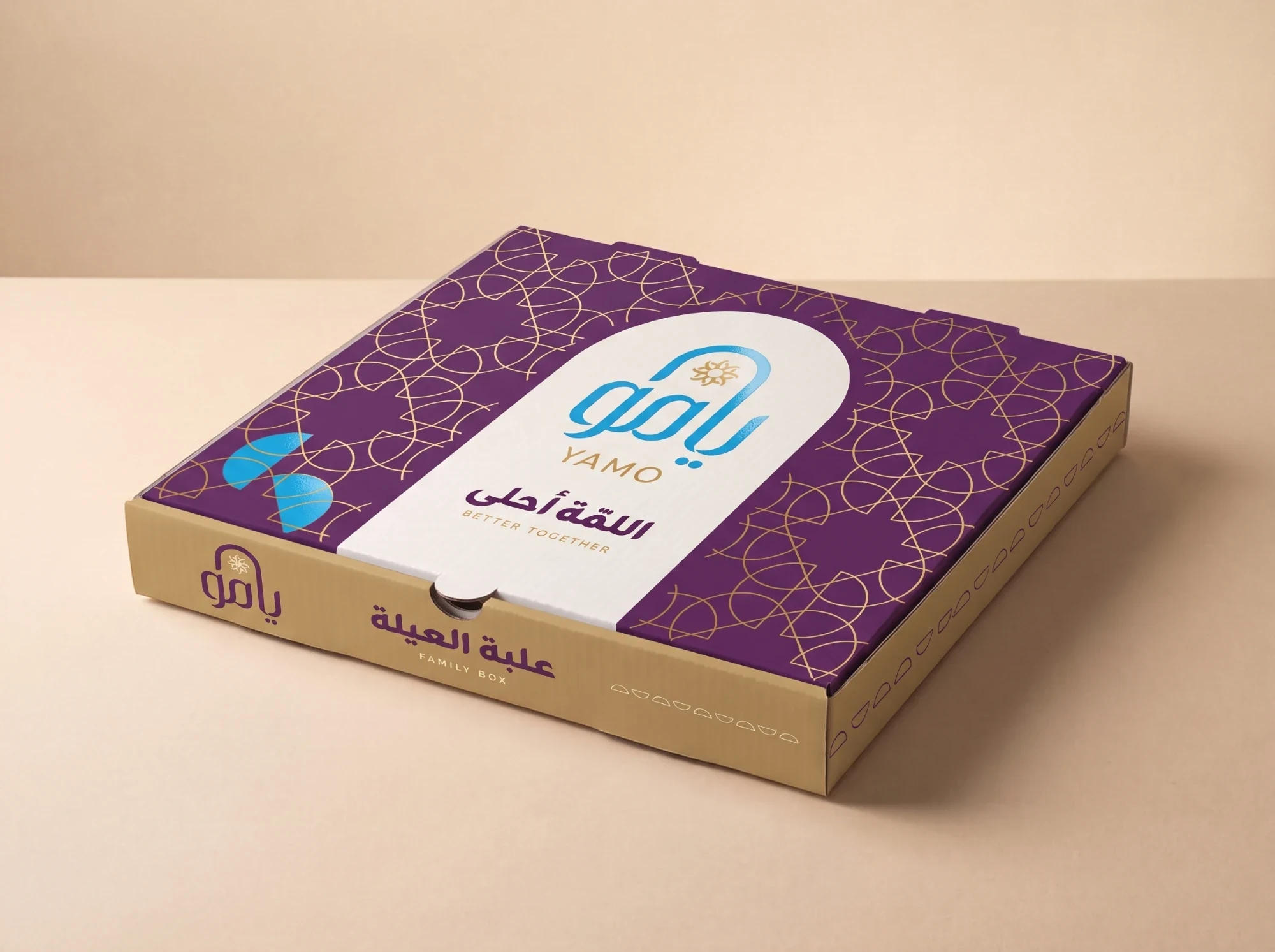 A plum and gold box with the blue logo in a cream arch above اللمّة أحلى, BETTER TOGETHER, and علبة العيلة, FAMILY BOX, on its side.